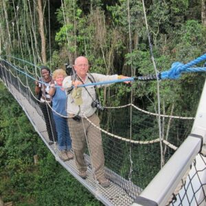 Two white tourists walking on the Nyungwe Canopy Walk in Nyungwe Forest National Park, Rwanda – a popular adventure in Nyungwe National Park offering stunning views of the rainforest.