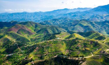 Aerial view of Rwanda’s lush green hills and terraced farms, ideal for Wildforms Safaris wildlife and nature tours.